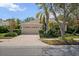Lovely home features a paved driveway, tile roof, lush landscaping, and an attached two-car garage at 866 Placid Lake Dr, Osprey, FL 34229