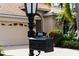 Up close shot of the home's mailbox with number plaque and a partial view of the home and two-car garage at 866 Placid Lake Dr, Osprey, FL 34229