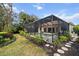Screened-in pool with a spa, patio furniture, beautiful landscaping and a stone walkway at 866 Placid Lake Dr, Osprey, FL 34229