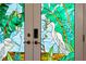Stained-glass front door featuring colorful heron and tropical leaf designs at 866 Placid Lake Dr, Osprey, FL 34229