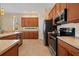 Well-lit kitchen featuring stainless steel appliances, granite countertops and a tile floor at 866 Placid Lake Dr, Osprey, FL 34229