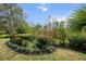 Lush landscaping featuring vibrant flowers and varied plants creating a serene and visually appealing outdoor garden at 866 Placid Lake Dr, Osprey, FL 34229