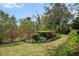Beautiful landscaping featuring lush greenery, flowering bushes, and a well-manicured lawn in this home's outdoor space at 866 Placid Lake Dr, Osprey, FL 34229