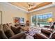 Comfortable living room with view of pool, fan and decorative ceiling at 866 Placid Lake Dr, Osprey, FL 34229