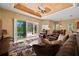 Living room with slider to patio, comfortable seating and decorative ceiling fan at 866 Placid Lake Dr, Osprey, FL 34229