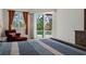 Main bedroom including a sitting area and sliding glass doors leading to a pool area at 866 Placid Lake Dr, Osprey, FL 34229