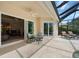 Covered patio featuring an outdoor table and chairs with sliding doors into the home at 866 Placid Lake Dr, Osprey, FL 34229