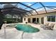 Sparkling pool and spa in screened-in lanai with patio furniture, grill and landscaping at 866 Placid Lake Dr, Osprey, FL 34229