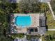Aerial view of the community pool, showcasing a large swimming area, plenty of seating, and lush landscaping at 866 Placid Lake Dr, Osprey, FL 34229