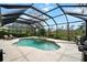 Beautiful pool and spa area enclosed by a screen, surrounded by landscaping and trees at 866 Placid Lake Dr, Osprey, FL 34229