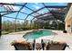 Well-maintained pool area with spa, covered lanai and lush landscaping outside of screen at 866 Placid Lake Dr, Osprey, FL 34229