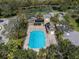 Aerial shot of the community pool and clubhouse, revealing a large pool deck, ample seating, and a relaxing atmosphere at 866 Placid Lake Dr, Osprey, FL 34229