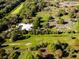 Expansive aerial view showing Culverhouse Community Garden amid green fields, trees and recreational areas at 8681 Daydream St, Sarasota, FL 34238