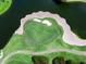 This is a stunning aerial view of the golf course, sandtrap, and ponds surrounding it at 8681 Daydream St, Sarasota, FL 34238