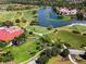 Beautiful aerial view of a golf course, lake, and club house at 8681 Daydream St, Sarasota, FL 34238