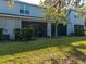 Exterior view of a multi-Gathering home with a screened-in patio, a yard, and a well-maintained backyard at 8681 Daydream St, Sarasota, FL 34238