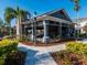 Community clubhouse offers covered seating, a stone facade, and lush landscaping at 8681 Daydream St, Sarasota, FL 34238