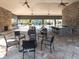 The clubhouse interior features a bar, fireplace, and comfortable seating near the pool at 8681 Daydream St, Sarasota, FL 34238