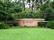 Tournament Players Club entrance with manicured lawn, mature trees, and attractive landscaping at 8681 Daydream St, Sarasota, FL 34238