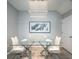 Elegant dining area featuring a modern chandelier and glass table at 8681 Daydream St, Sarasota, FL 34238
