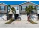 Charming townhome exterior with a private garage, stone accents, and fresh landscaping at 8681 Daydream St, Sarasota, FL 34238
