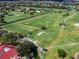 An amazing aerial view of the golf course showing the green, sand trap and lake at 8681 Daydream St, Sarasota, FL 34238