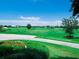 Lush green golf course with well-maintained fairways and greens under a bright blue sky, ready for a game at 8681 Daydream St, Sarasota, FL 34238