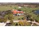 Stunning aerial view of the golf course, clubhouse, and beautifully landscaped grounds at 8681 Daydream St, Sarasota, FL 34238
