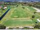A stunning aerial view of the golf course showing the players, green and sand traps at 8681 Daydream St, Sarasota, FL 34238