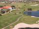 Aerial view of the manicured golf course showcasing the clubhouse and surrounding community at 8681 Daydream St, Sarasota, FL 34238