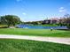 Scenic golf course view with golfers and lake at 8681 Daydream St, Sarasota, FL 34238