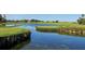 A stunning view of the golf course and serene lake at 8681 Daydream St, Sarasota, FL 34238