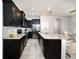 Spacious kitchen featuring dark cabinetry, stainless steel appliances, and ample counter space at 8681 Daydream St, Sarasota, FL 34238