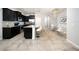 Modern kitchen featuring dark cabinets, a large island, and stainless steel appliances at 8681 Daydream St, Sarasota, FL 34238
