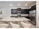 Bright kitchen with dark cabinets, stainless steel appliances, and a spacious island at 8681 Daydream St, Sarasota, FL 34238