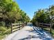 Picturesque walking trail lined with wooden fences and lush trees, ideal for a peaceful stroll at 8681 Daydream St, Sarasota, FL 34238