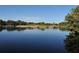 Tranquil golf course water feature showcasing still, reflective water and surrounding lush greenery, ideal for golf enthusiasts at 8681 Daydream St, Sarasota, FL 34238
