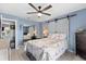 Bedroom featuring barn doors, mirrored closet doors, and a floral-patterned quilt on the bed at 8719 Gaillard Ave, North Port, FL 34287