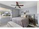 Bedroom with a gray-toned palette, complete with a ceiling fan and a large window offering natural light at 8719 Gaillard Ave, North Port, FL 34287