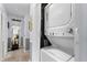 Convenient laundry closet with stacked washer and dryer, located in a hallway with wood flooring at 8719 Gaillard Ave, North Port, FL 34287