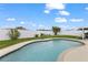 Backyard showcasing a swimming pool, green lawn, and a white fence, perfect for outdoor enjoyment at 8719 Gaillard Ave, North Port, FL 34287