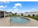 Outdoor pool surrounded by lush greenery, landscaping, and a well-maintained backyard at 8719 Gaillard Ave, North Port, FL 34287