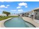 Pool area with a view of the backyard, patio and manicured landscaping at 8719 Gaillard Ave, North Port, FL 34287