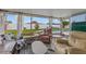 Spacious screened porch features comfortable seating and views of the pool and backyard at 8719 Gaillard Ave, North Port, FL 34287