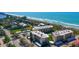 Aerial view showcasing condos near a sandy beach with beautiful ocean views and blue skies at 8779 Midnight Pass Rd # 406H, Sarasota, FL 34242