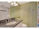 Well-maintained bathroom featuring a granite vanity and decorative tiling, with tiled floors at 8779 Midnight Pass Rd # 406H, Sarasota, FL 34242