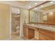 Bright bathroom with granite counters, wood cabinets, and a tile shower with glass door at 8779 Midnight Pass Rd # 406H, Sarasota, FL 34242