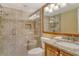 This bathroom features tile surround and backsplash, glass shower and granite topped wood cabinets at 8779 Midnight Pass Rd # 406H, Sarasota, FL 34242