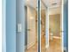 Bathroom with tiled floor, tub with shower, and half-open door at 8779 Midnight Pass Rd # 406H, Sarasota, FL 34242