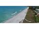 Relaxing beach view with blue ocean water and people enjoying the beach at 8779 Midnight Pass Rd # 406H, Sarasota, FL 34242